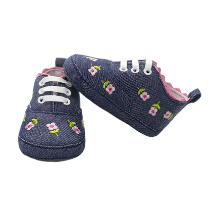 A pair of adorable pink lace floral first walker shoes for infant girls, featuring soft cotton and sweet design.