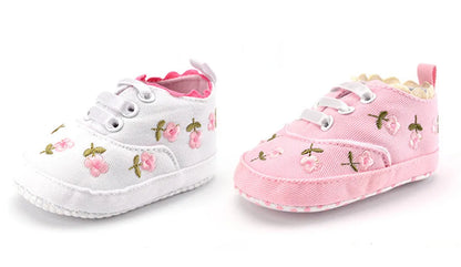 Navy baby girl's crib shoes with intricate lace floral details, perfect first walker soft sole footwear.