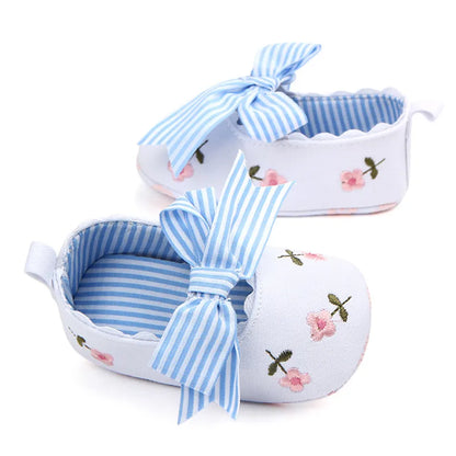 Baby girl's stylish white lace floral first walker shoes, offering both comfort and an elegant look.