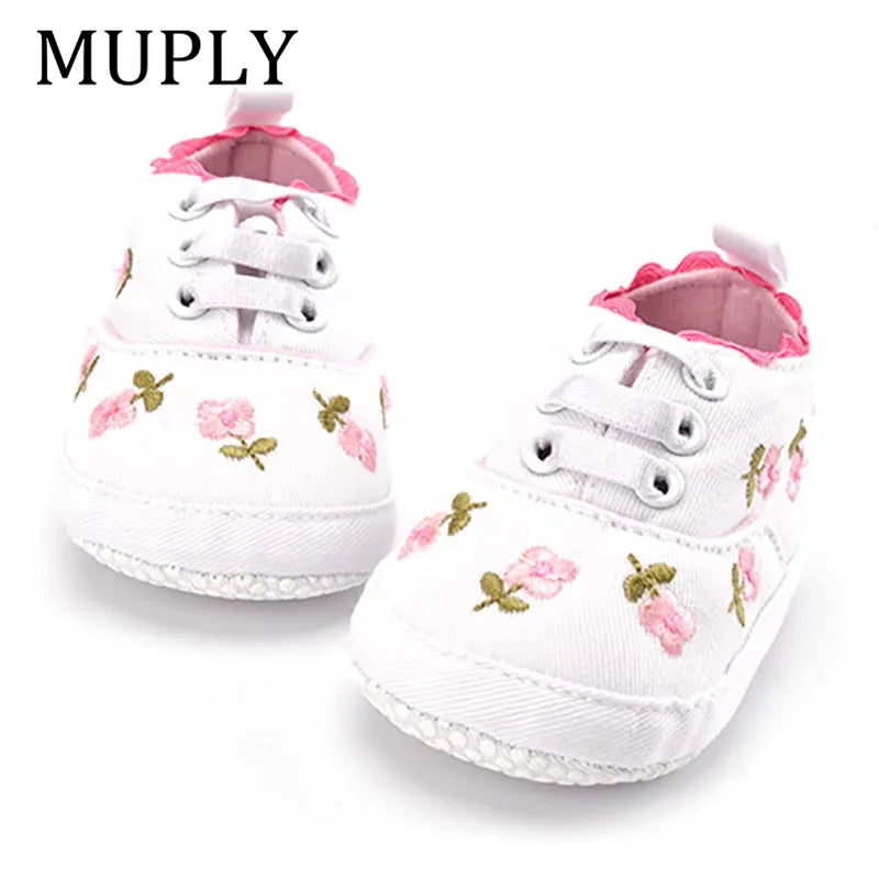 Charming navy blue baby girl's first walker shoes with elegant lace floral accents, cotton crib shoes.