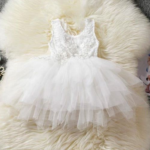Young girl twirling in a beautiful backless ruffle tutu dress, ideal for toddlers' party wear.