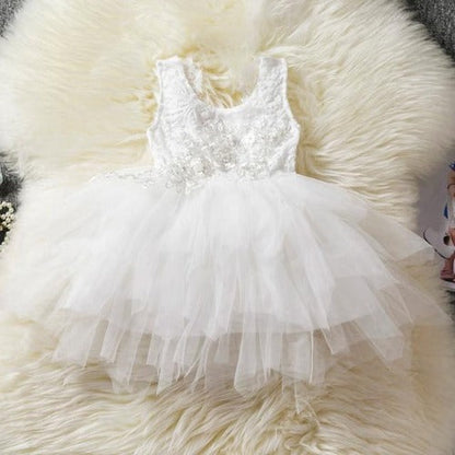 Young girl twirling in a beautiful backless ruffle tutu dress, ideal for toddlers' party wear.