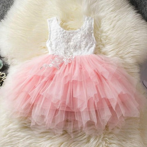 Elegant white backless princess tutu dress with layered ruffles, a staple for girls' special events.
