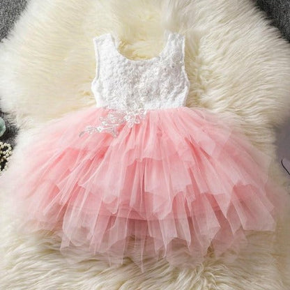 Elegant white backless princess tutu dress with layered ruffles, a staple for girls' special events.