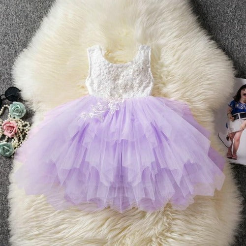 Girls' backless ruffle tutu dress in a vibrant blue, showcasing a flowing skirt and party design.