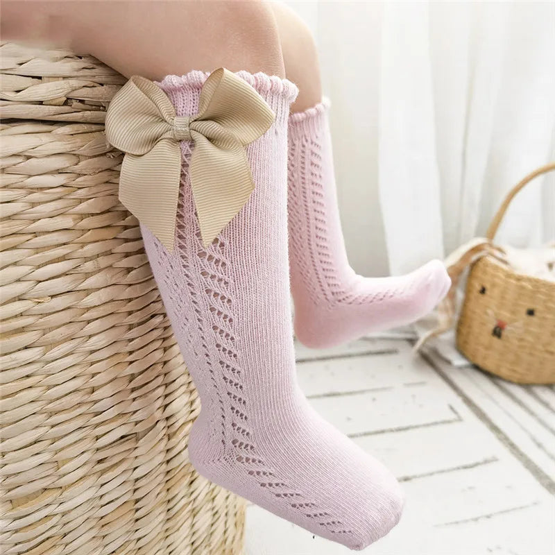 Fashionable purple bow knee-high socks for young girls and boys.