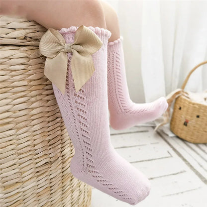 Fashionable purple bow knee-high socks for young girls and boys.