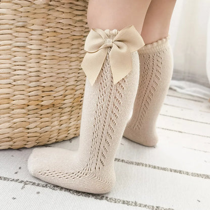 Assorted pack of colorful bow knee-high socks for children's everyday wear.
