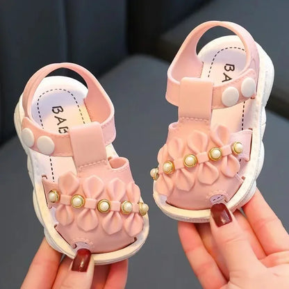 Girls' footwear: pink bow sandals, a sweet addition to any summer outfit.