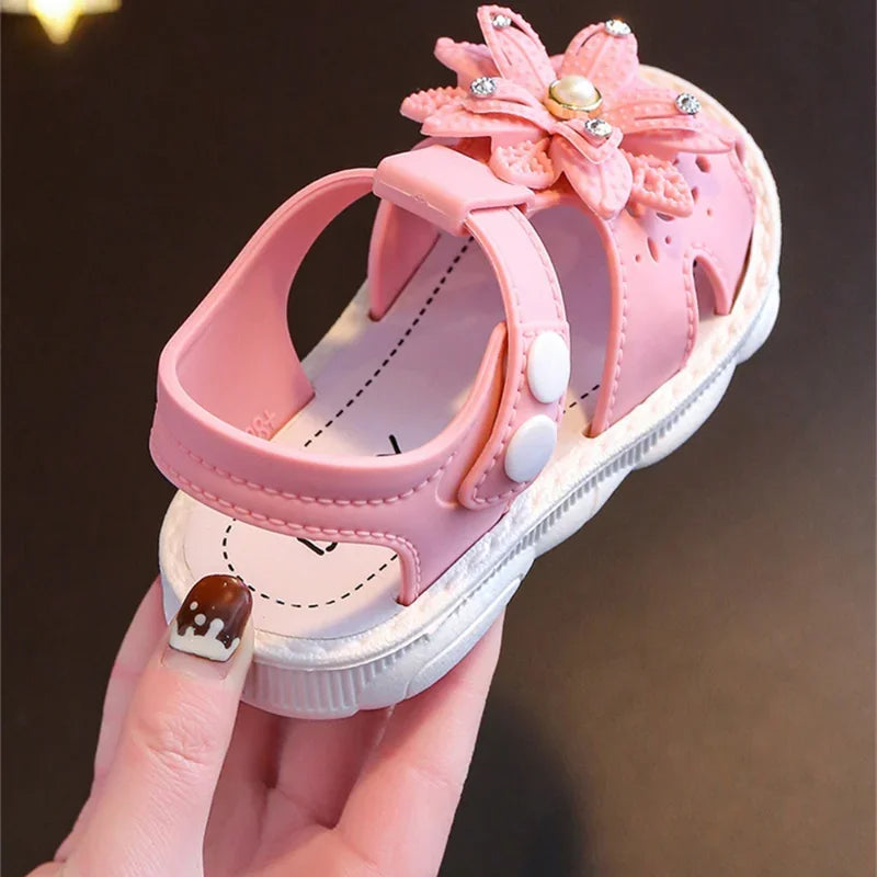 Girls' summer sandals with a pink bow, ideal for comfortable play.