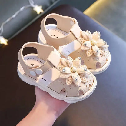 Profile view of a beige bow summer sandal for toddlers, durable and cute.