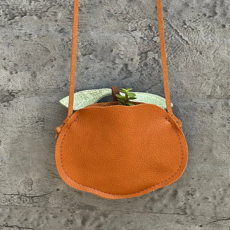Back view of a PU leather cartoon crossbody bag, showing adjustable strap for toddlers