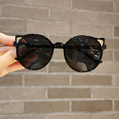 Little girl showing off her new yellow cartoon cat eye sunglasses, UV protection, cute toddler eyewear