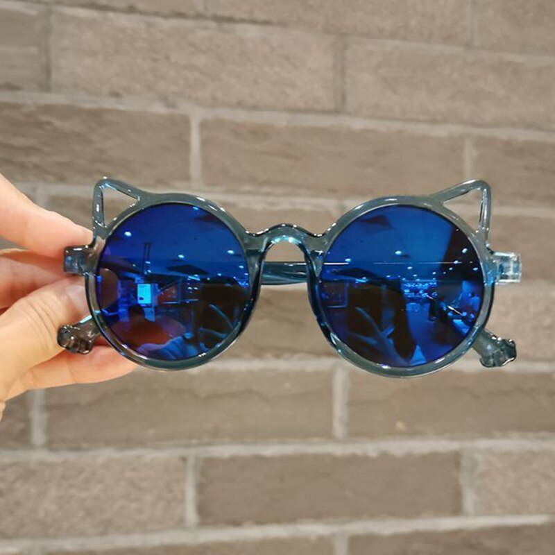 Various colors of girls' cartoon cat eye sunglasses displayed, UV protection for kids, baby accessories