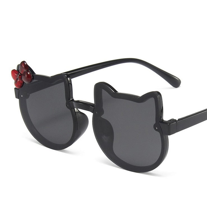 Close-up of cat-eye kids' sunglasses showing UV protection lenses, a must-have baby accessory for sun safety.