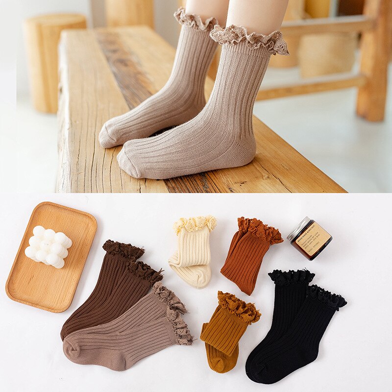 Girls' warm cotton ruffle mid-calf socks in a classic black, suitable for winter and school wear.