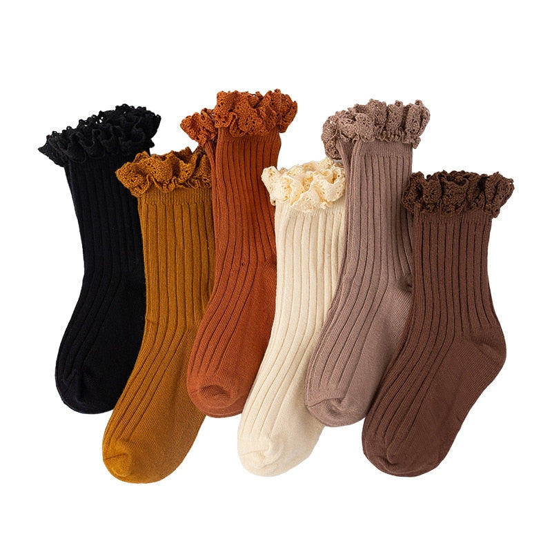 Soft white cotton ruffle mid-calf socks for girls, cozy and breathable kids' apparel.