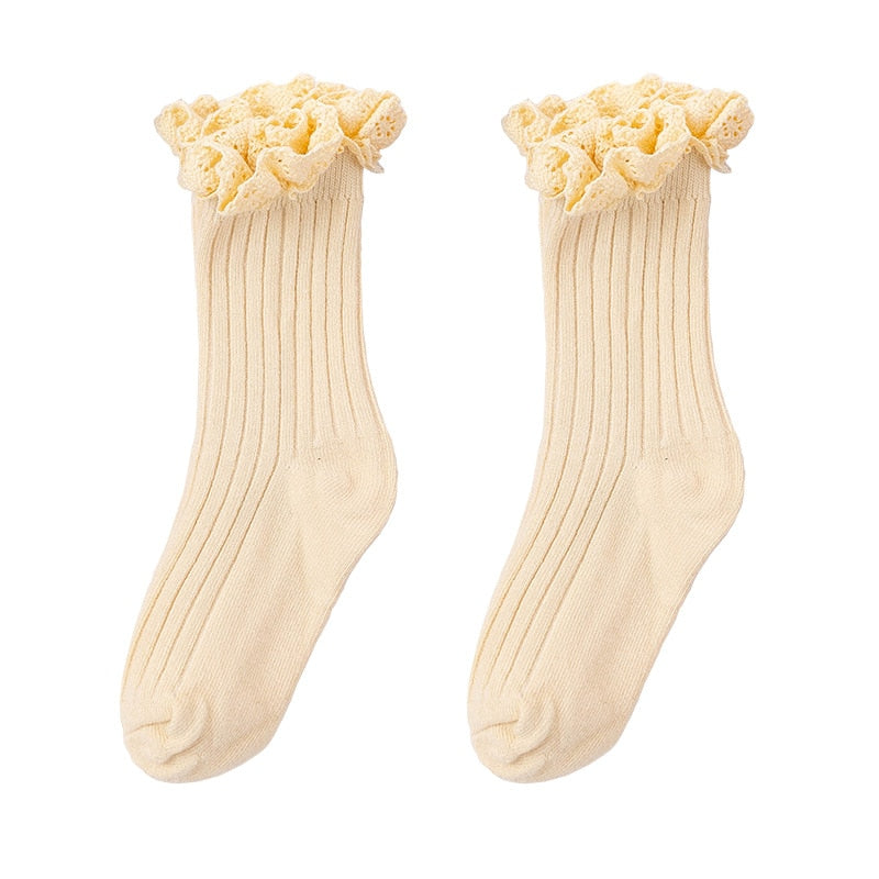 Folded stack of colorful cotton ruffle mid-calf socks for girls, ready for gifting or storage.