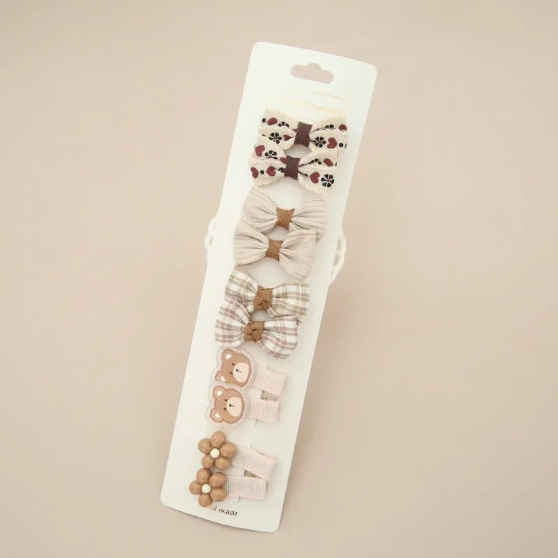 Sweet floral fabric hair bow and clip, a charming addition for young girls' delicate hair.