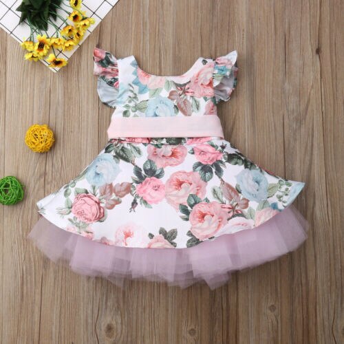 Toddler girl's pink party dress with delicate flower appliques and stylish batwing design.