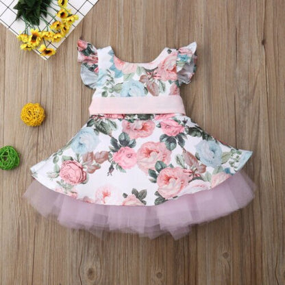 Toddler girl's pink party dress with delicate flower appliques and stylish batwing design.
