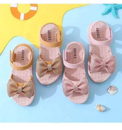 Side view of a green girls' bow sandal, showcasing flexible and quick-dry material