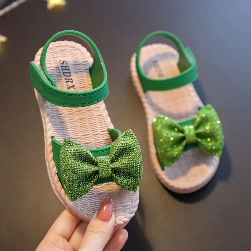 Toddler wearing yellow bow sandals, playing outdoors, breathable and comfy
