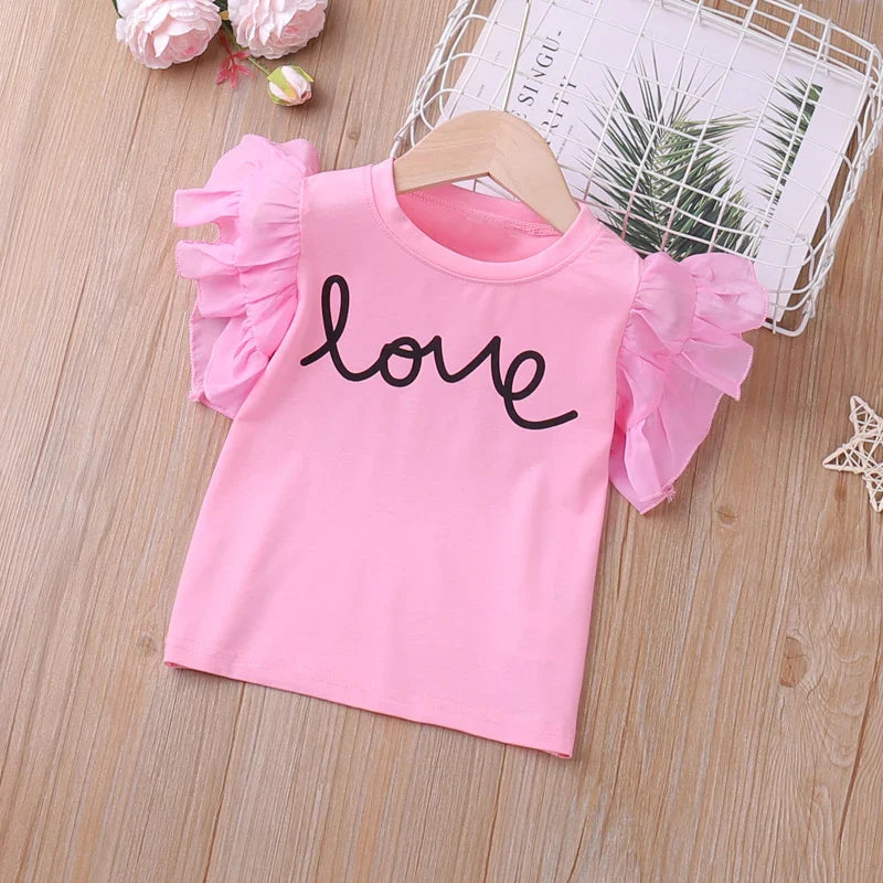 Cute toddler girl's summer outfit featuring pink top with butterfly sleeves and matching shorts, cotton-blend.