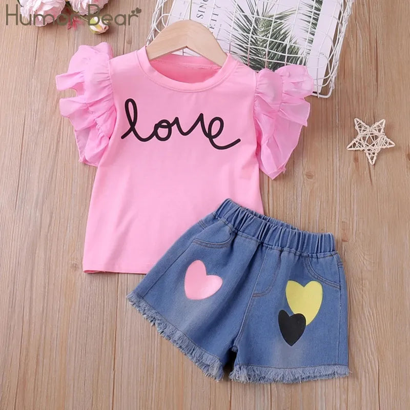 Girls' kidswear summer fashion set in pink with butterfly sleeves, ideal for comfortable play.