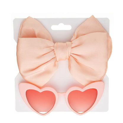 Cute children's gift set featuring pink heart sunglasses and a matching bow headband, ideal for toddlers.