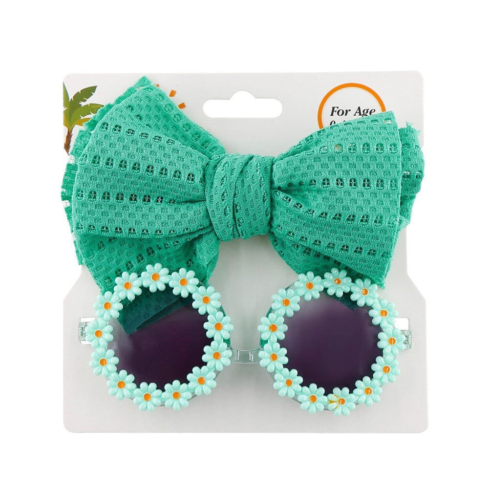 Children's fashion accessory: purple UV protection sunglasses with a cute bow headband.