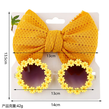 Green kids' UV protection sunglasses and matching bow headband, ideal for sunny days.
