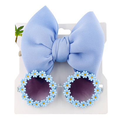 Kid's trendy purple sunglasses and matching bow headband, essential UV protection eyewear.