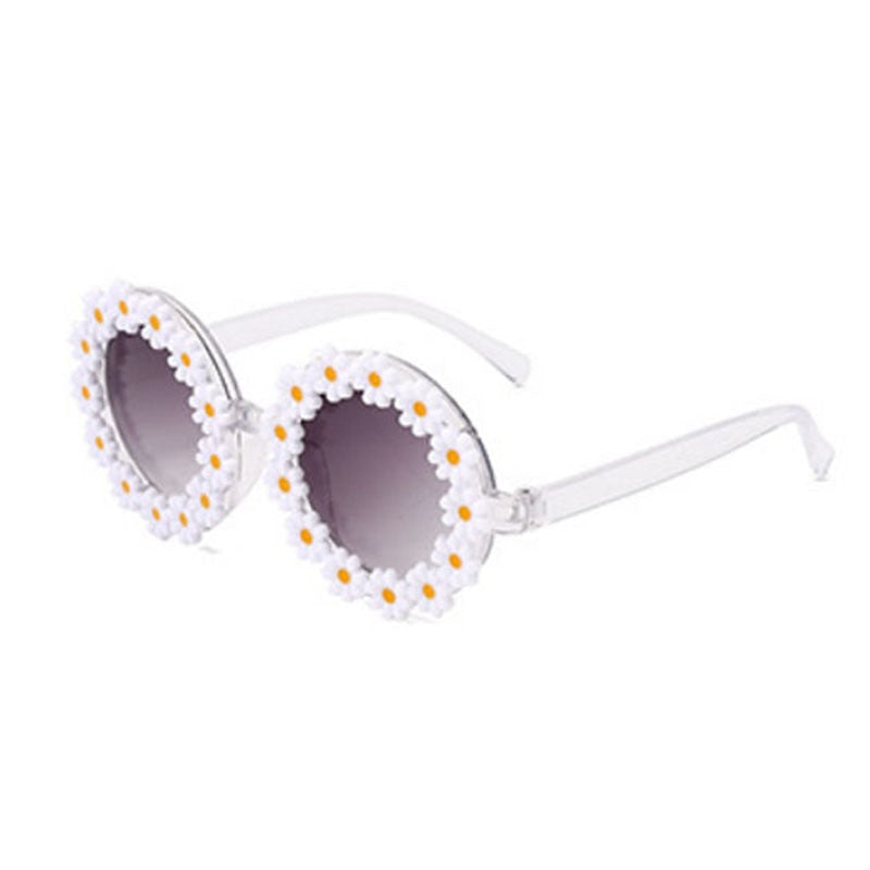 Fashionable green kids' sunglasses and coordinating bow headband, perfect for sun protection.