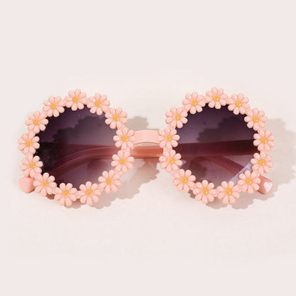 Pink kids' sunglasses with heart frames and a matching bow headband, sun protection fashion.