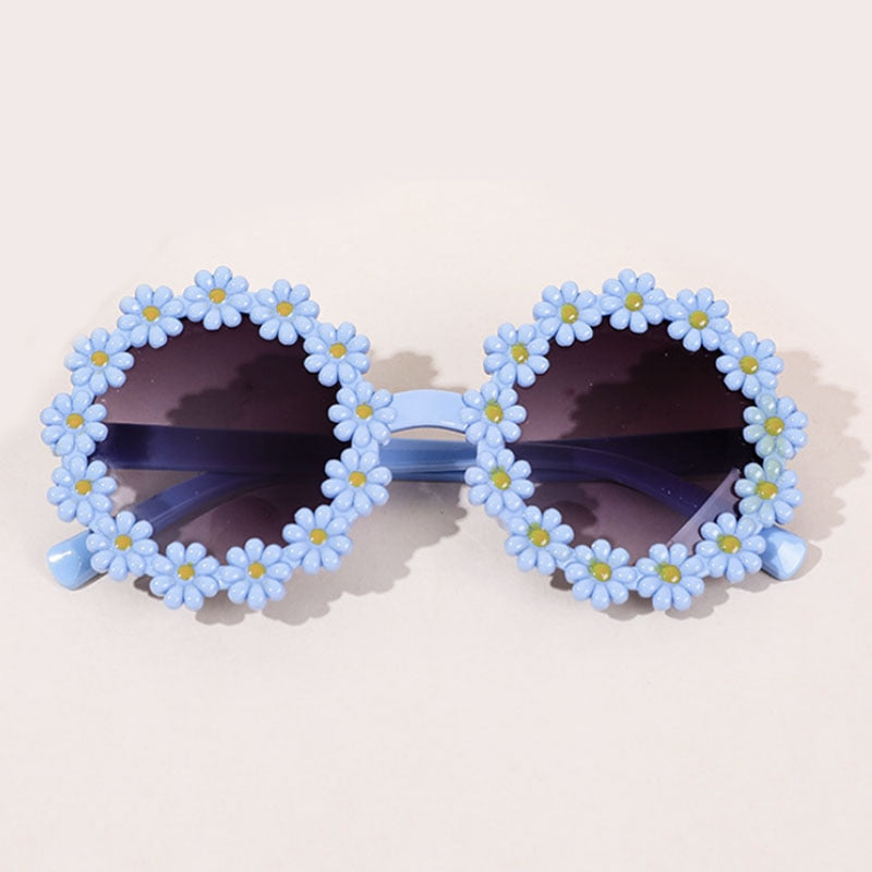 Close-up of a pink bow headband paired with trendy kids' UV protection sunglasses.