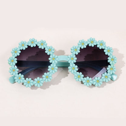 A display of multiple colored kids' UV protection sunglasses and bow headbands.