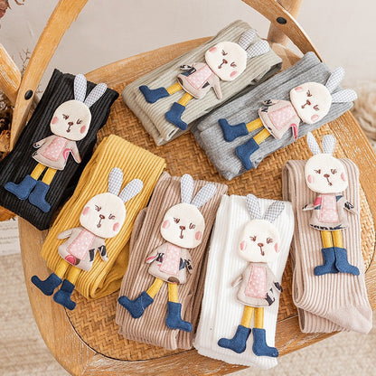 Adorable pink knitted girls' pantyhose with white cartoon rabbit pattern, soft and cozy for toddlers.