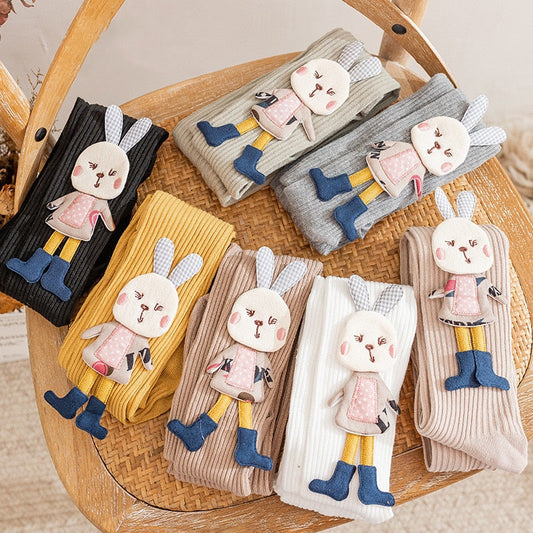 Adorable pink knitted girls' pantyhose with white cartoon rabbit pattern, soft and cozy for toddlers.