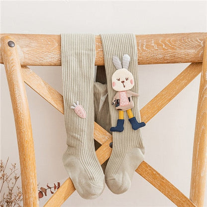 Cute pink girls' knitted pantyhose with white rabbit motif, perfect for baby clothing and kids' fashion.