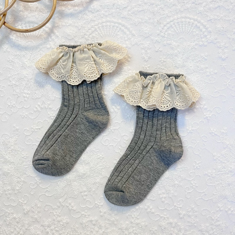 High-angle view of a single pink lace frilly flower cotton sock, showcasing details