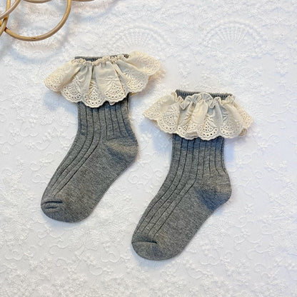 High-angle view of a single pink lace frilly flower cotton sock, showcasing details