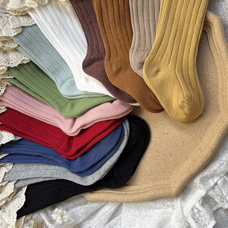 A stack of assorted lace frilly flower cotton socks for girls, showcasing colors