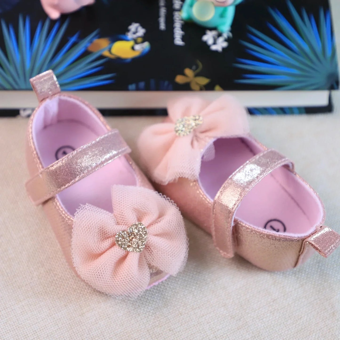 Pink lace princess toddler shoes, combining breathability with a charming butterfly knot for baby girls.