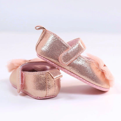 First steps pink princess shoes for baby girls, featuring delicate lace and convenient hook and loop closure.