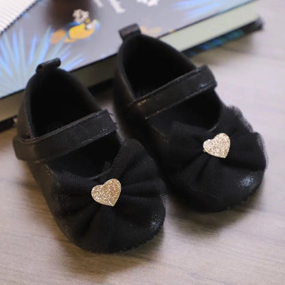 Pink lace and butterfly knot toddler shoes, designed for baby girls' comfort and fashion.