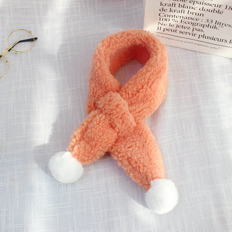 Child wearing a cozy plush candy print scarf, showcasing warmth and cute style for winter apparel.
