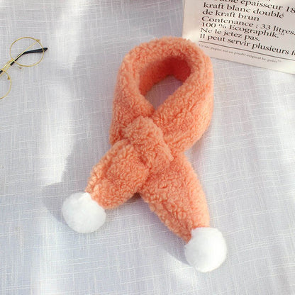 Child wearing a cozy plush candy print scarf, showcasing warmth and cute style for winter apparel.