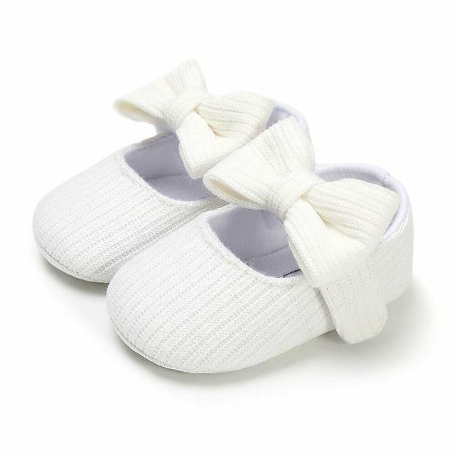 Stylish girls' first walker shoes featuring a pretty bow, soft sole for baby's early steps.