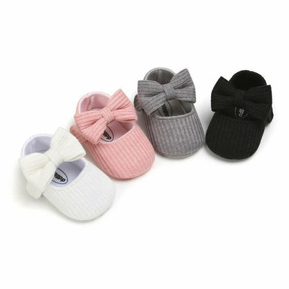Soft sole baby girl shoes featuring a sweet bow, ideal for first steps and toddler comfort.